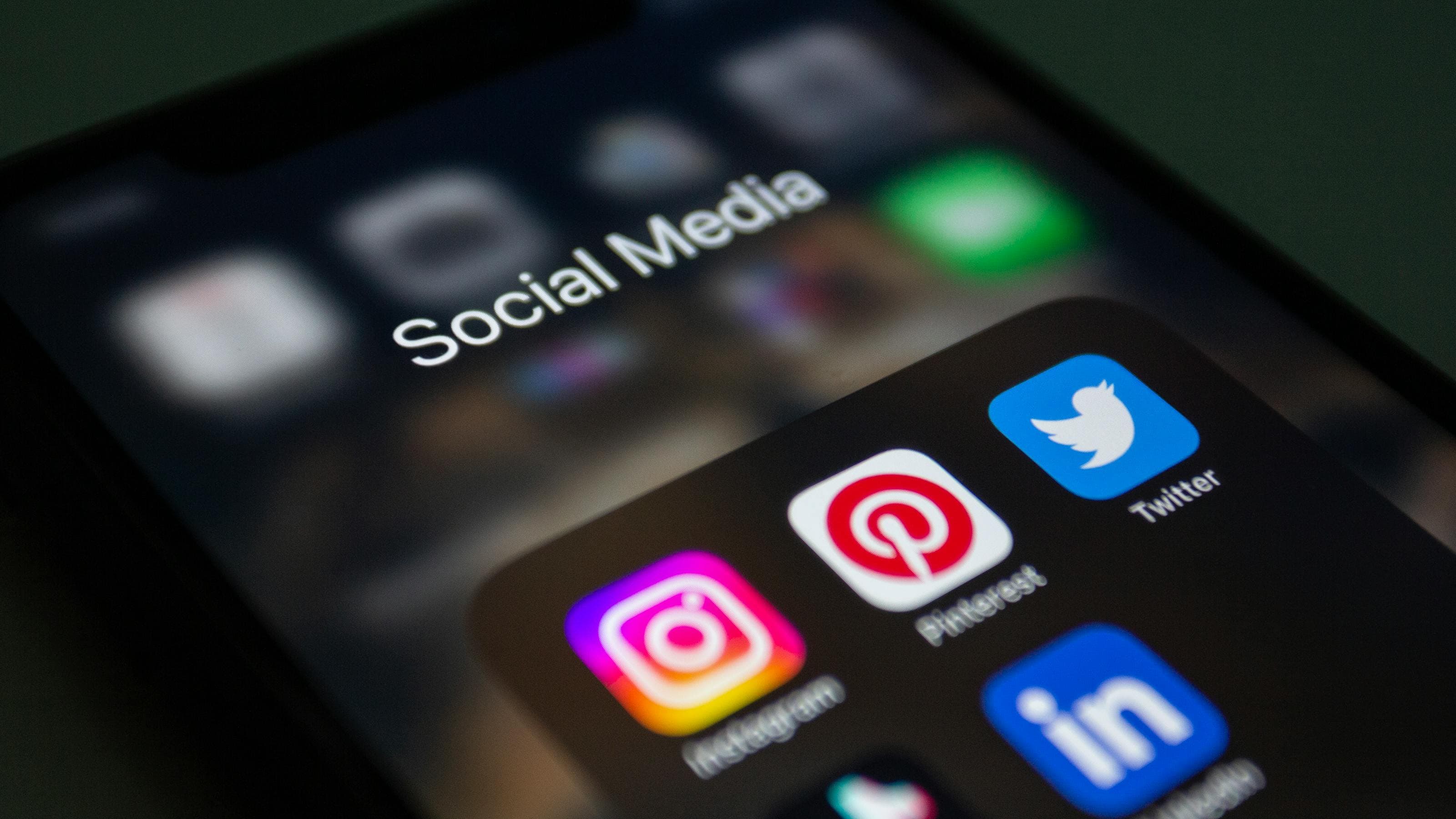Hands using social media apps on smartphone